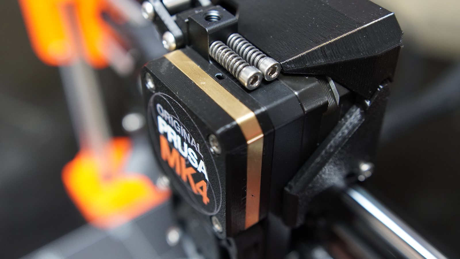 Close-up of the Prusa MK4 extruder motor and surrounding hardware.