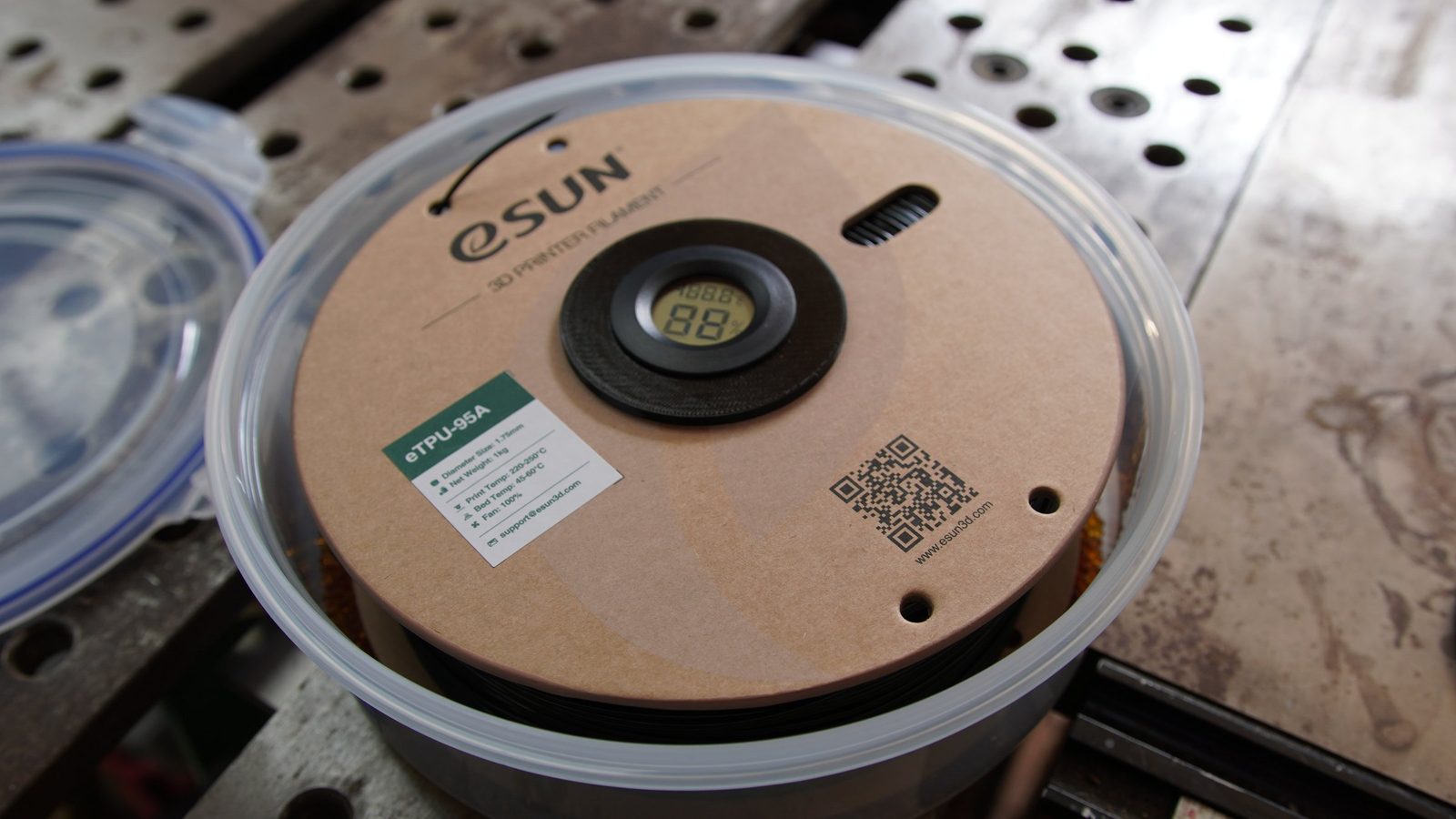 An eSun eTPU-95A spool sitting in the open container with a round hygrometer in its hub.