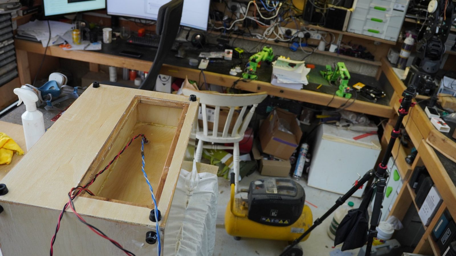 Rear cut-out in a plywood speaker cabinet with internal wiring visible.