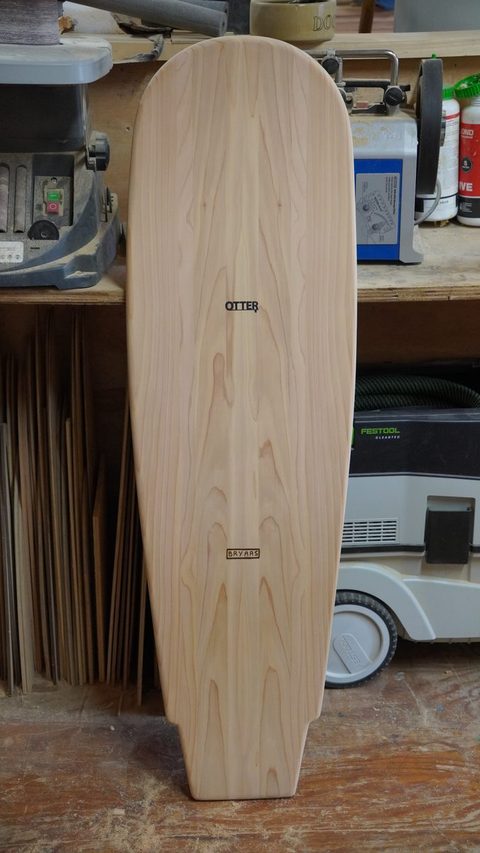 The finished belly board standing upright in the workshop.