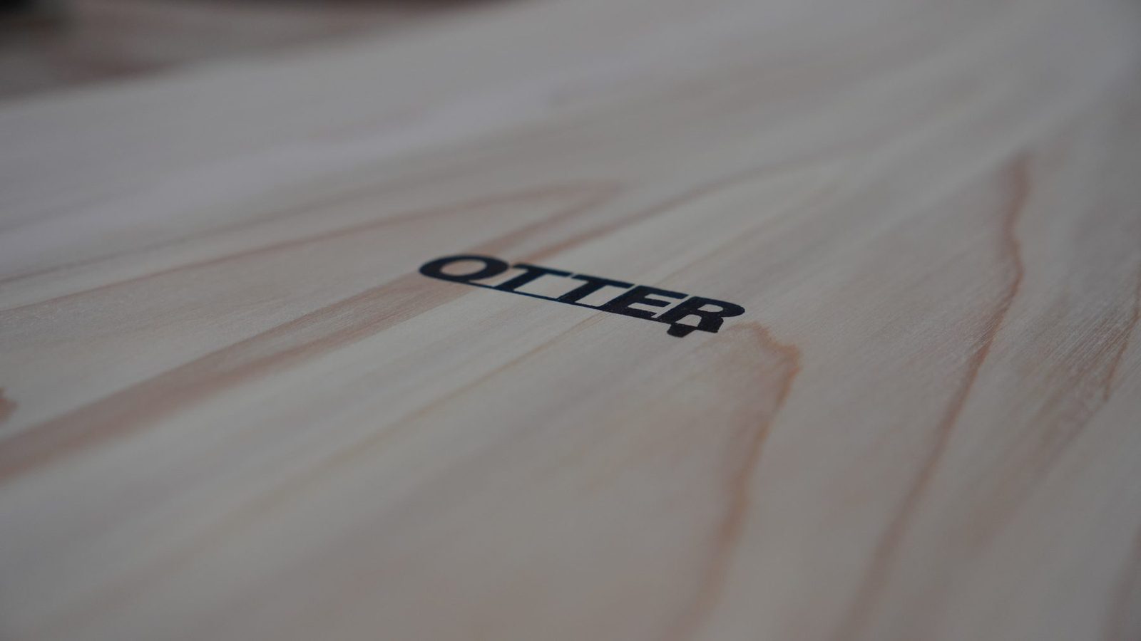 Close-up of the Otter maker's mark on the wooden belly board.