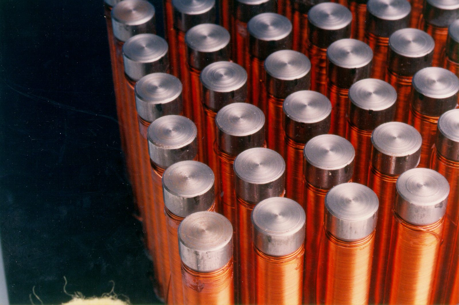 An array of hand-wound electromagnet coils for the robotic chessboard.