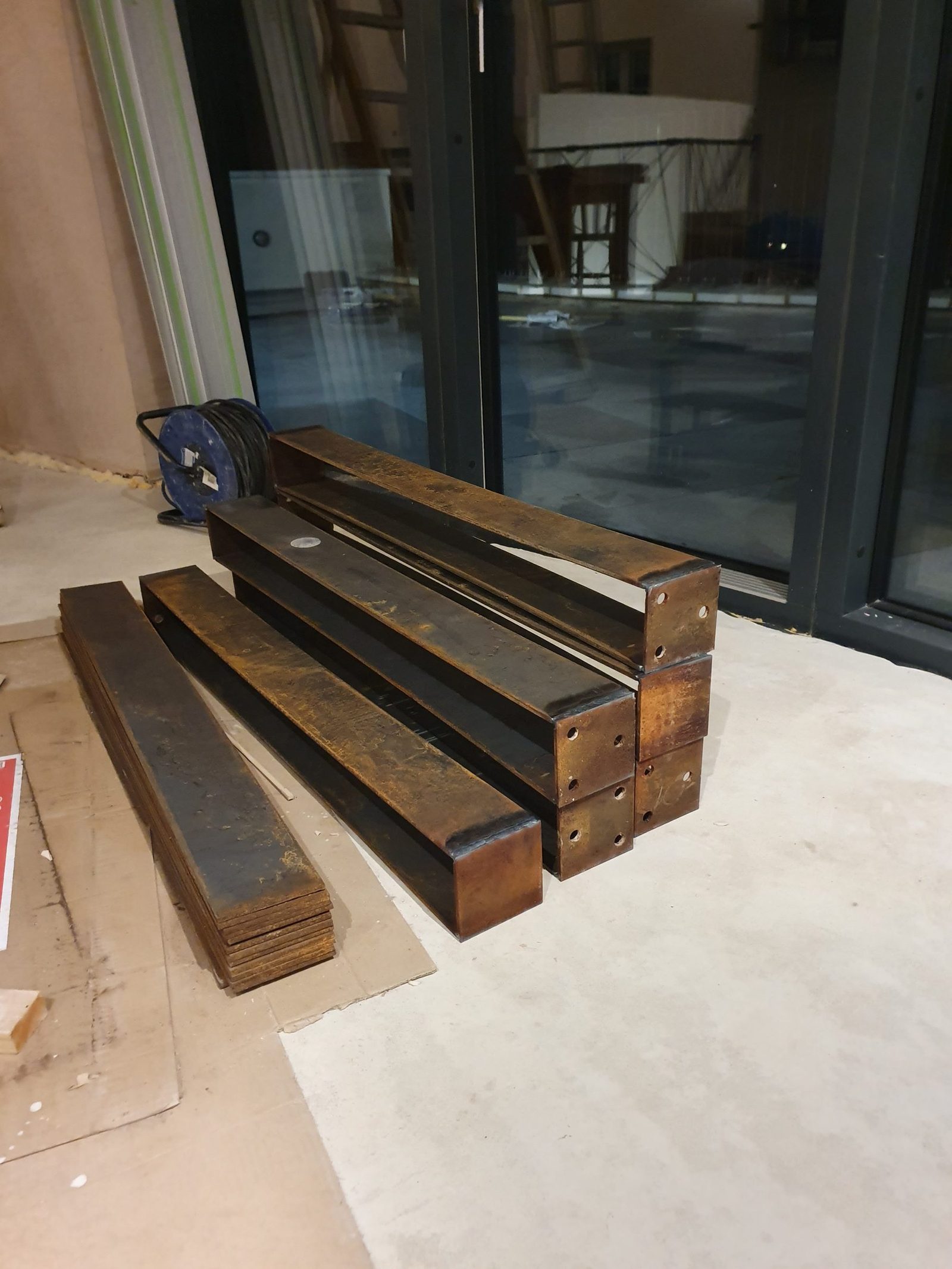 Corten steel sections stacked and ready for installation.