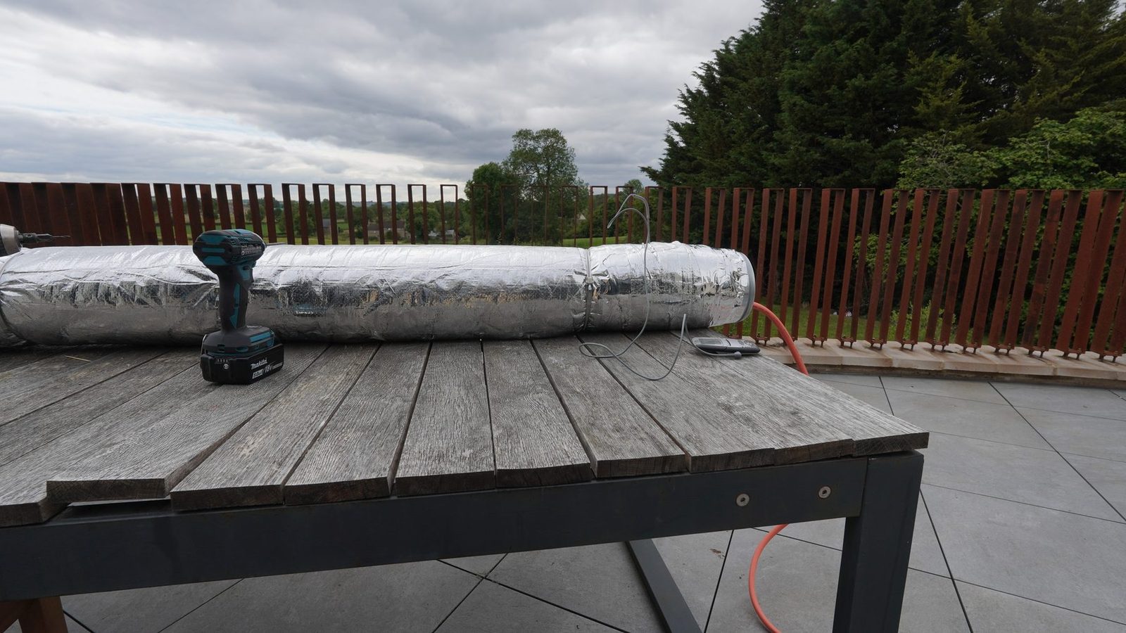 A timber steam box on a terrace for bending skirting board.