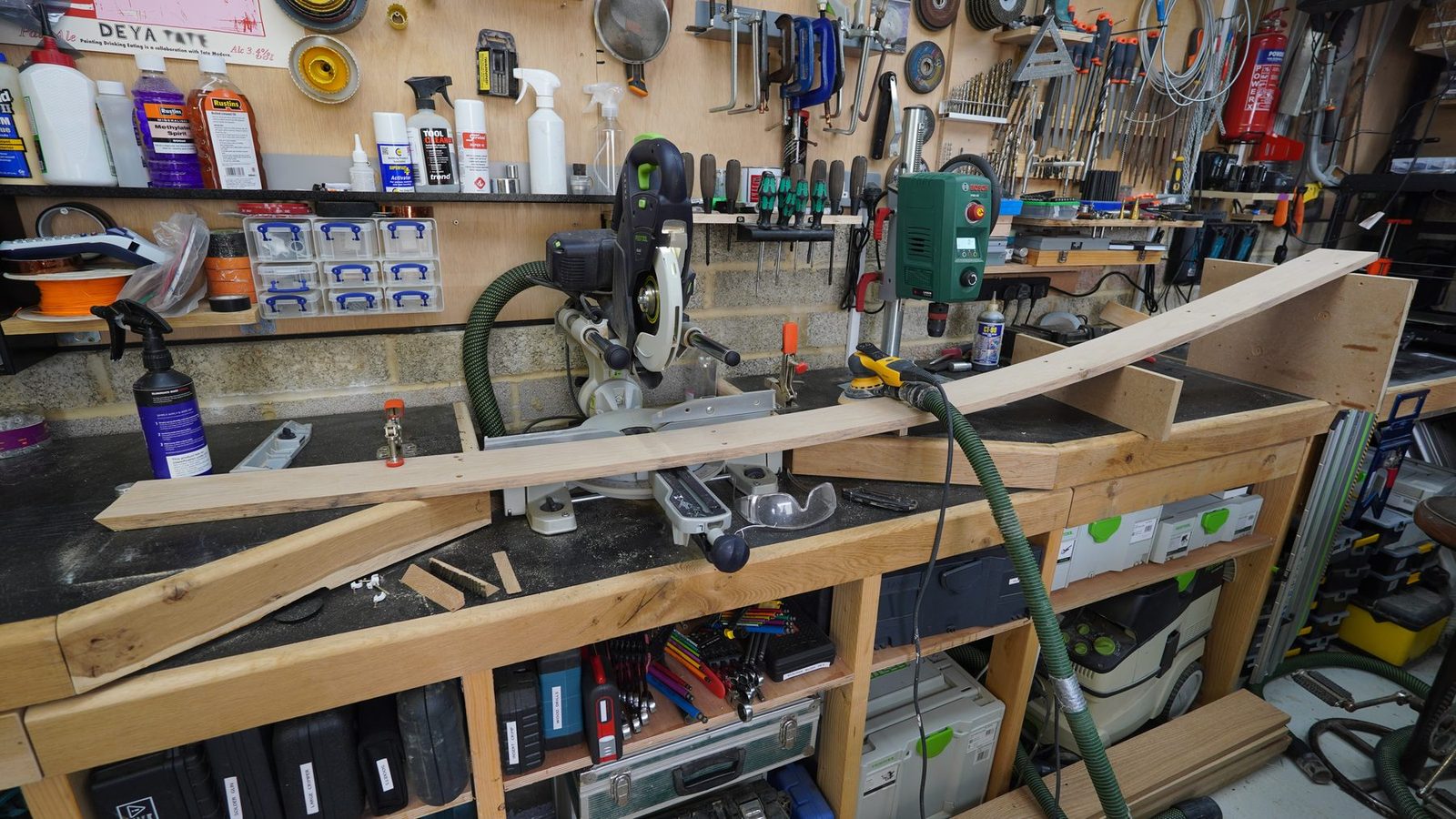 A long piece of skirting board being worked on in the workshop.
