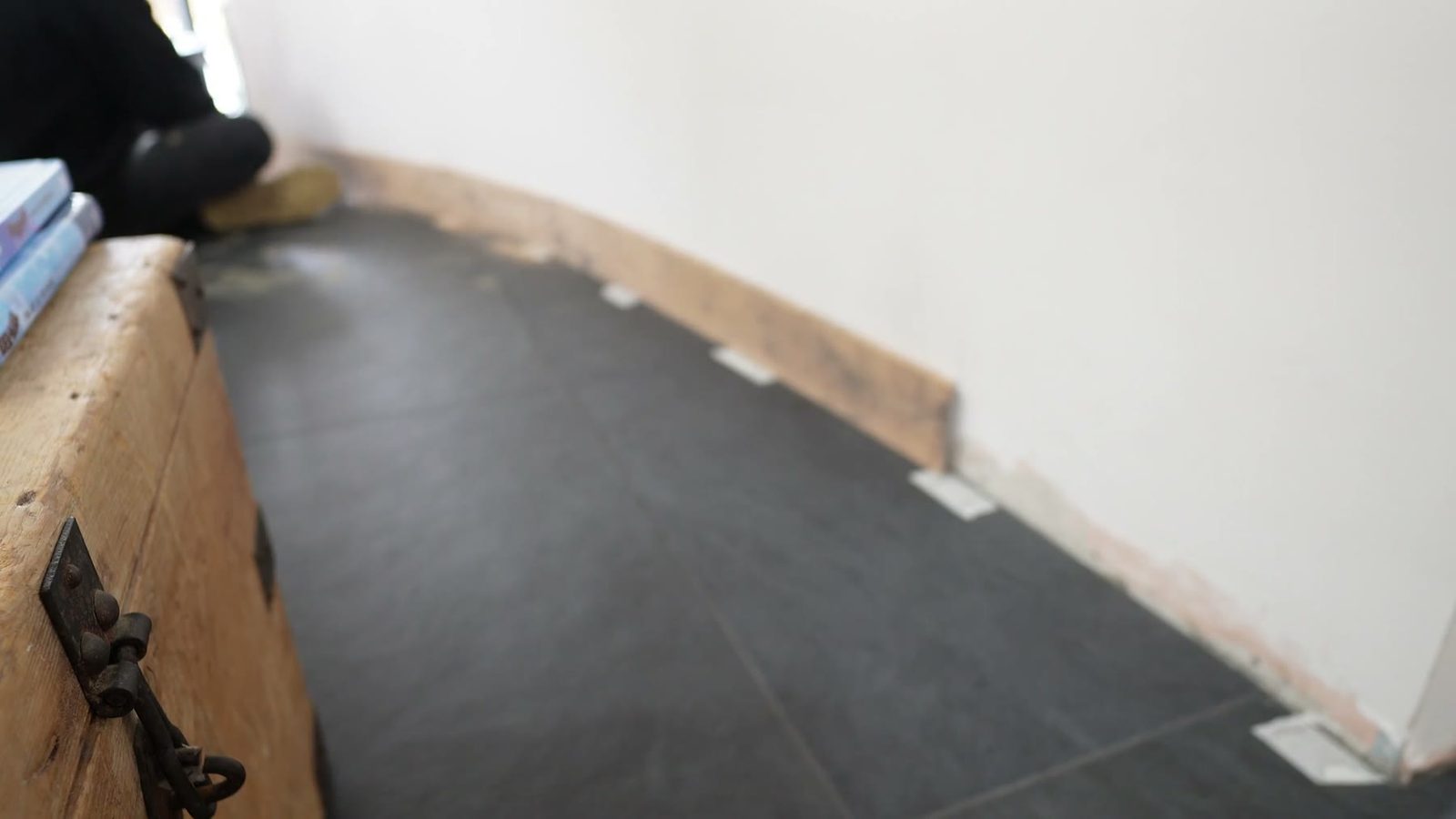 First fit of a curved skirting board section against the curved wall.