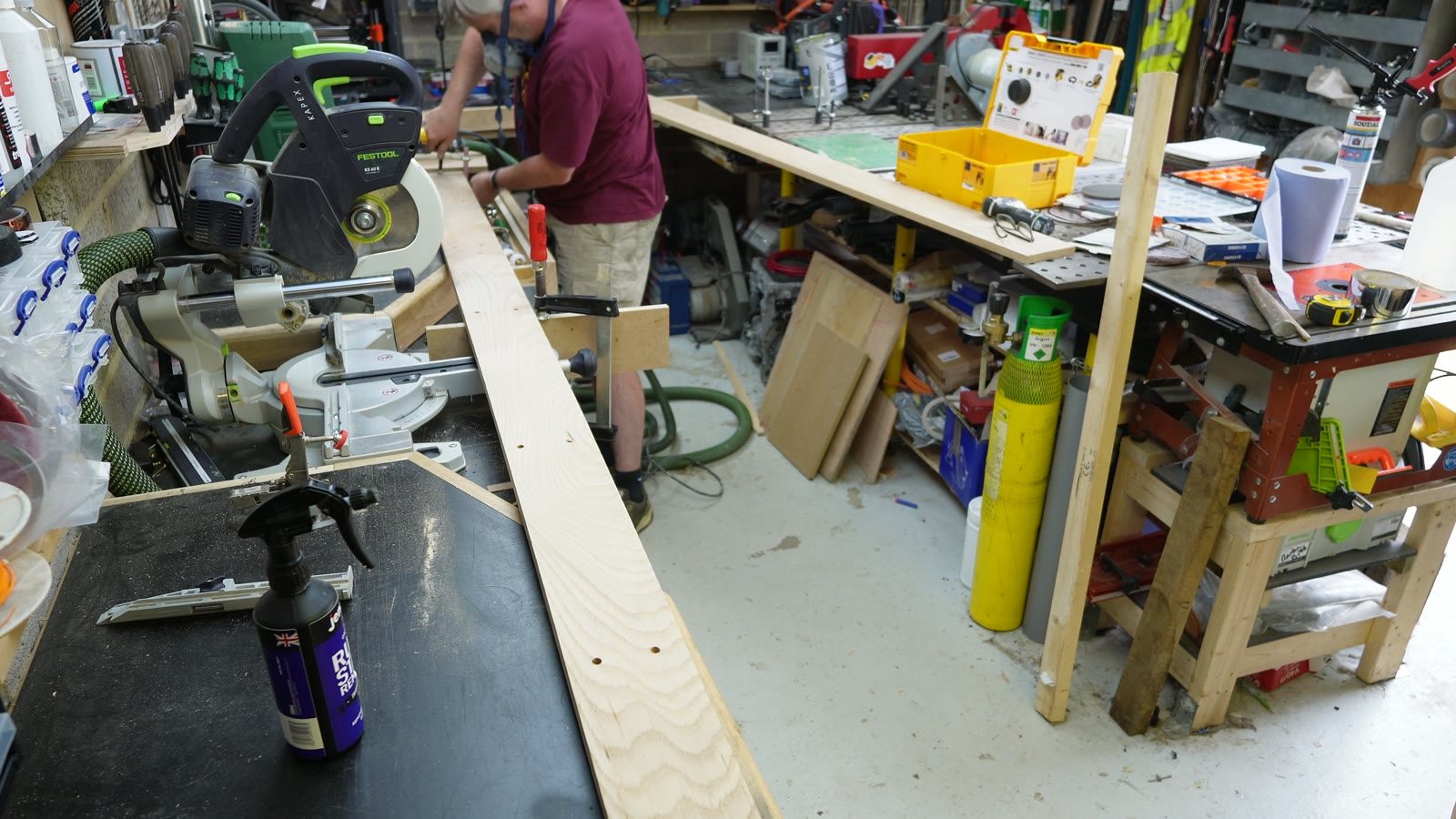 A curved timber skirting board laid out on a workbench before fitting.