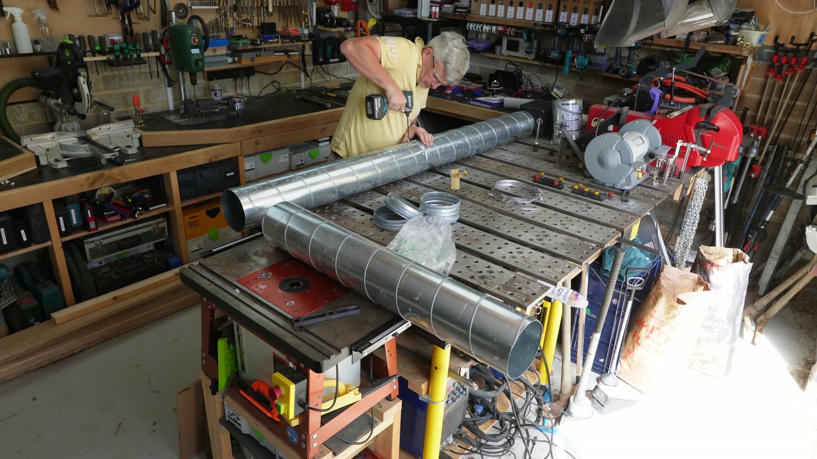 A long foil-wrapped steam box being built across the workshop bench.
