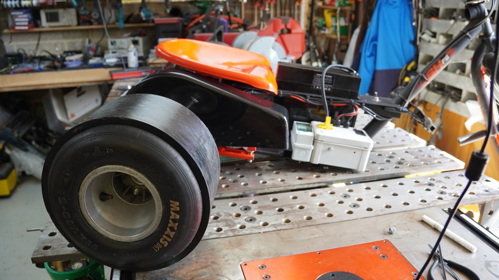 Drive wheel and frame detail on the workshop table.