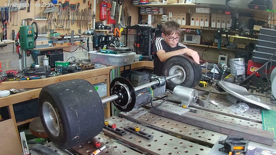 Lincoln fitting wheels to the drift trike in the workshop.