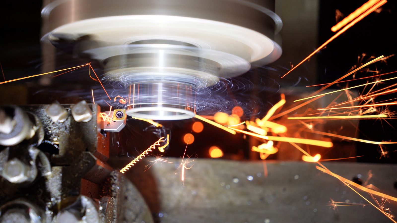 Sparks flying sideways from the lathe tool.
