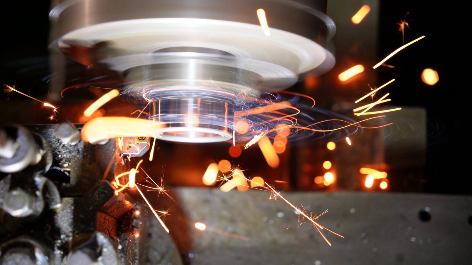 A bright shower of sparks near the cutting tool.