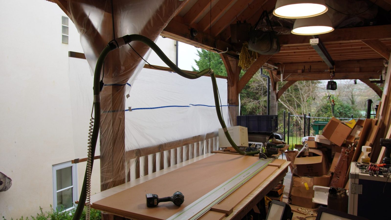 Long boards and tools set up outside before the bookcase build.