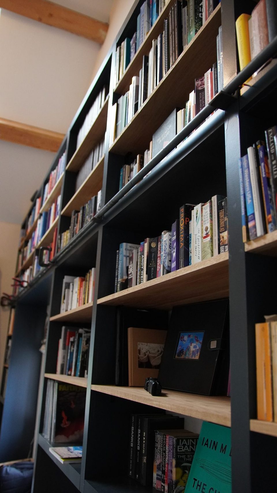 Close view down the shelves and dark bookcase frame.