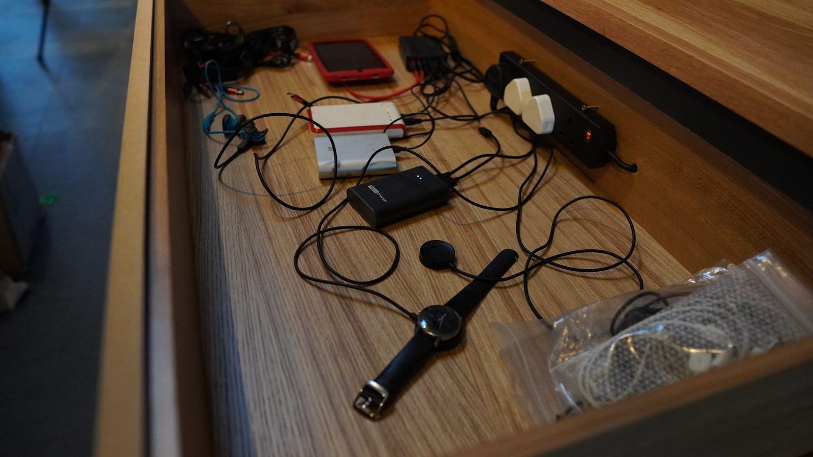 Wiring and electronics laid out in the console drawer.