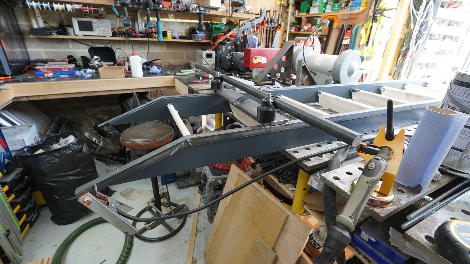 Metal ladder frame on the workbench during fabrication.