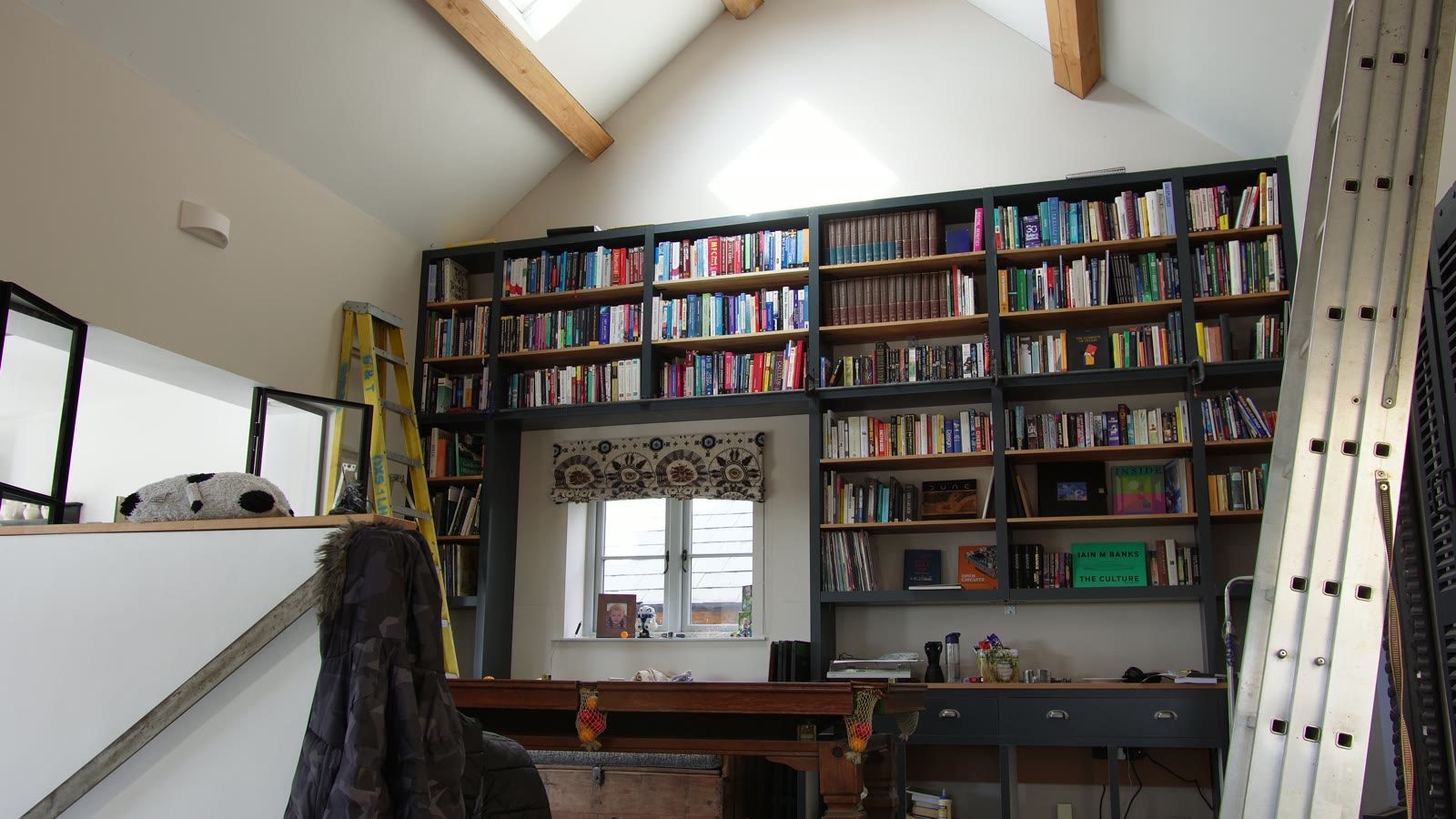 The bookcase and rolling ladder in the finished room.