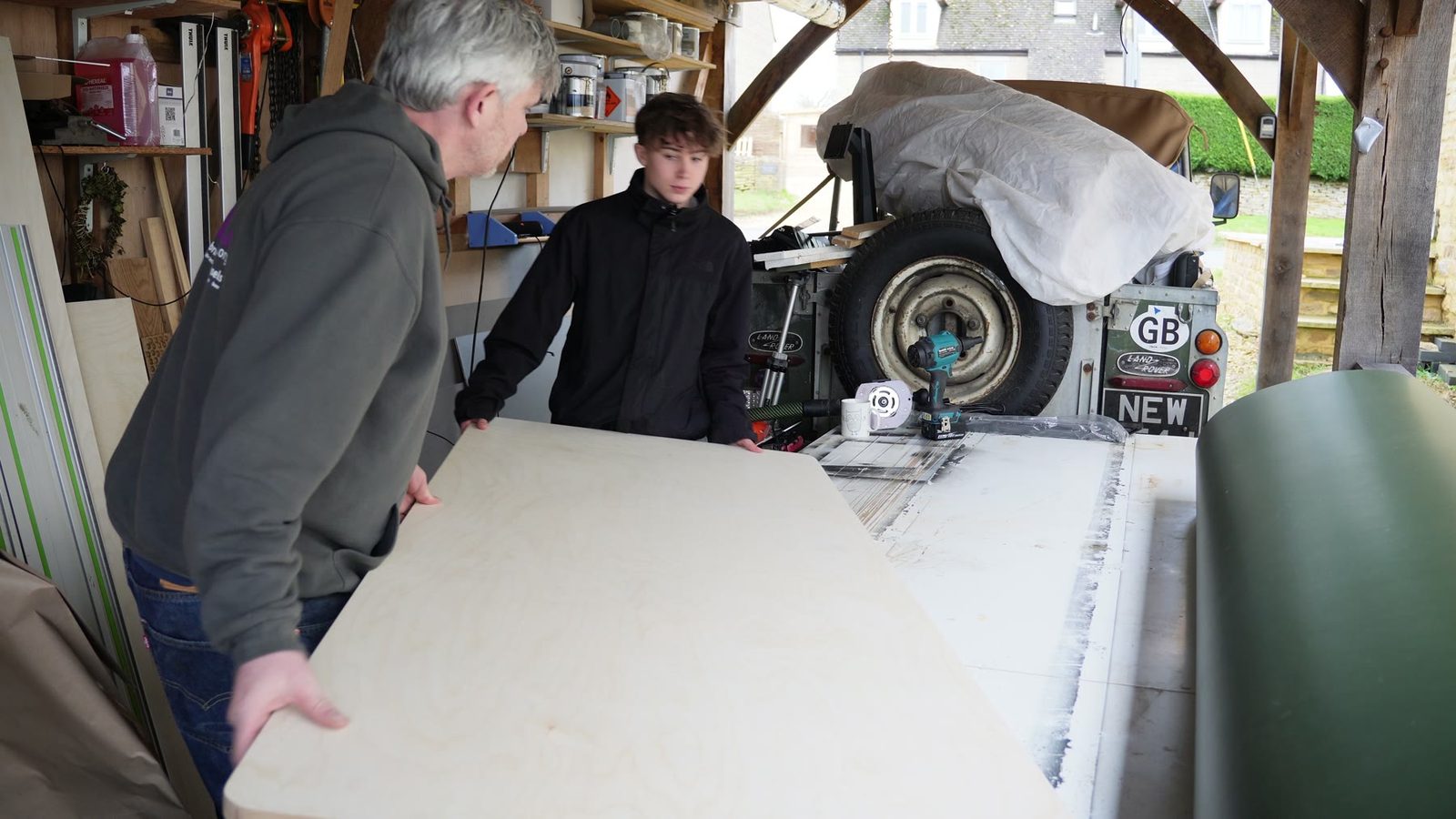 A large pale desk top being test fitted in the workshop.
