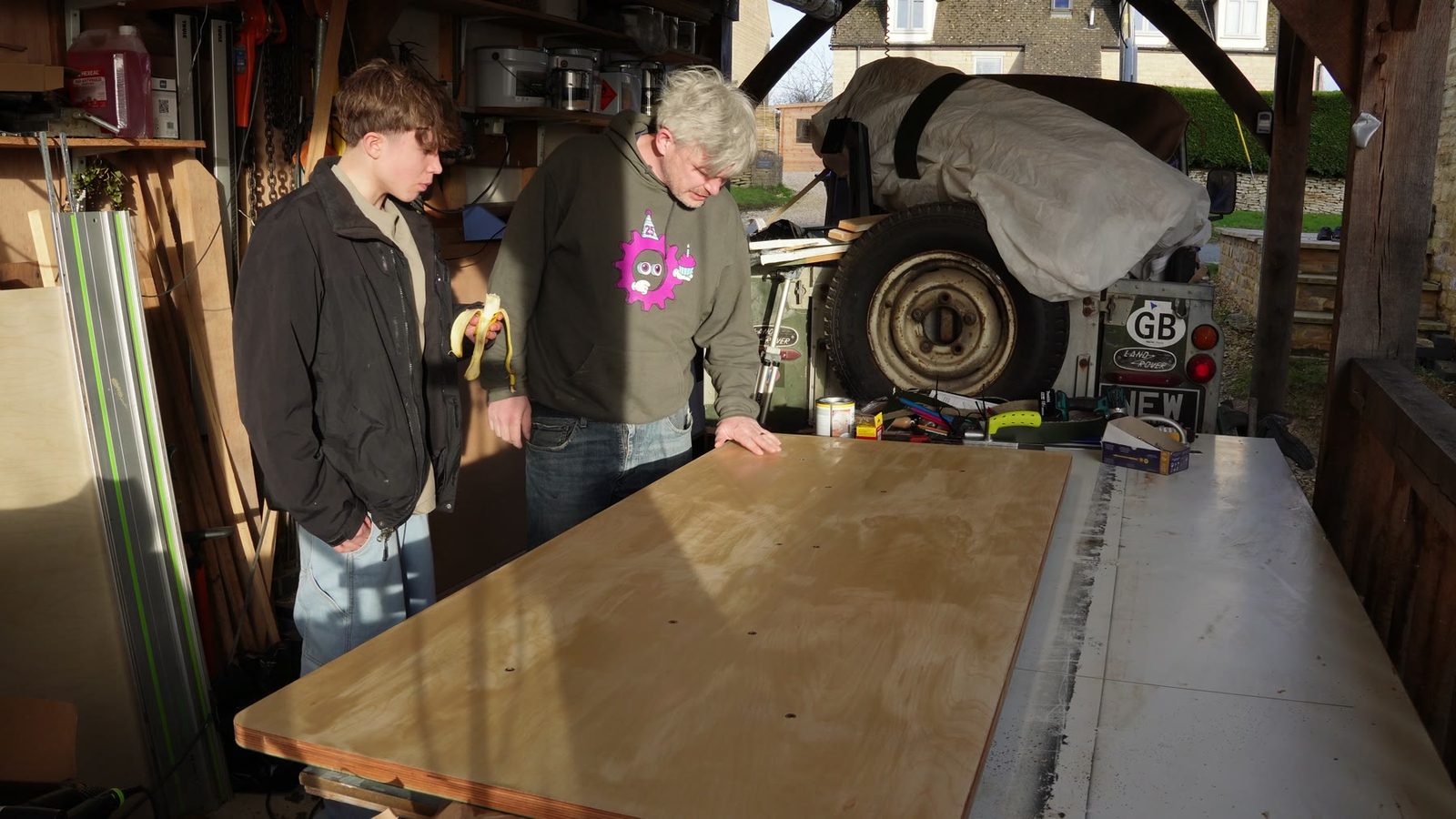 The finished pale timber desk top laid out in the workshop.