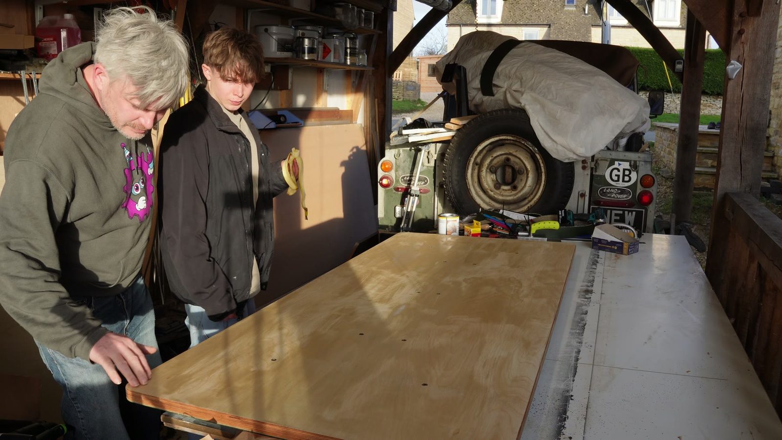 Daniel and his son beside the finished timber top for a motorised standing desk.