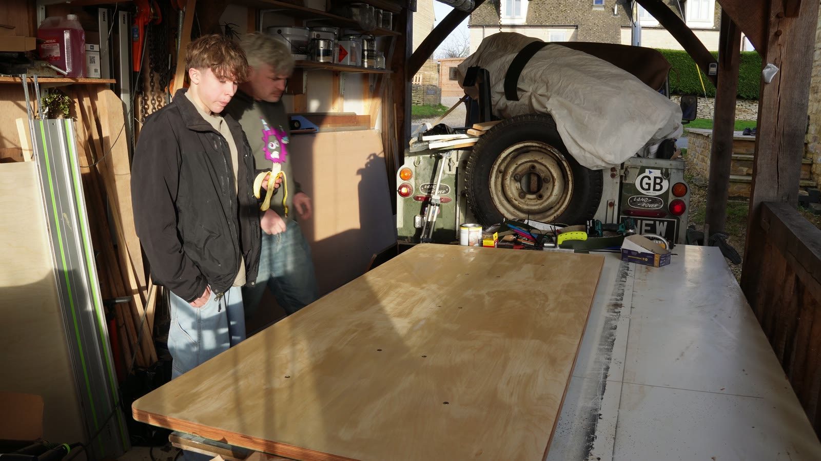 Daniel and his son standing by the assembled motorised desk during testing.