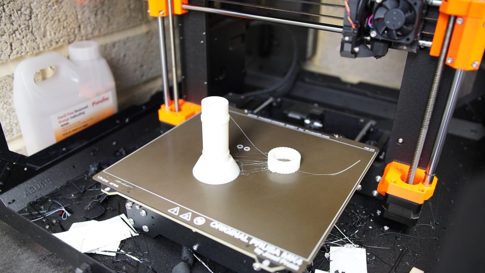 Printed robot arm coupler on a printer bed.