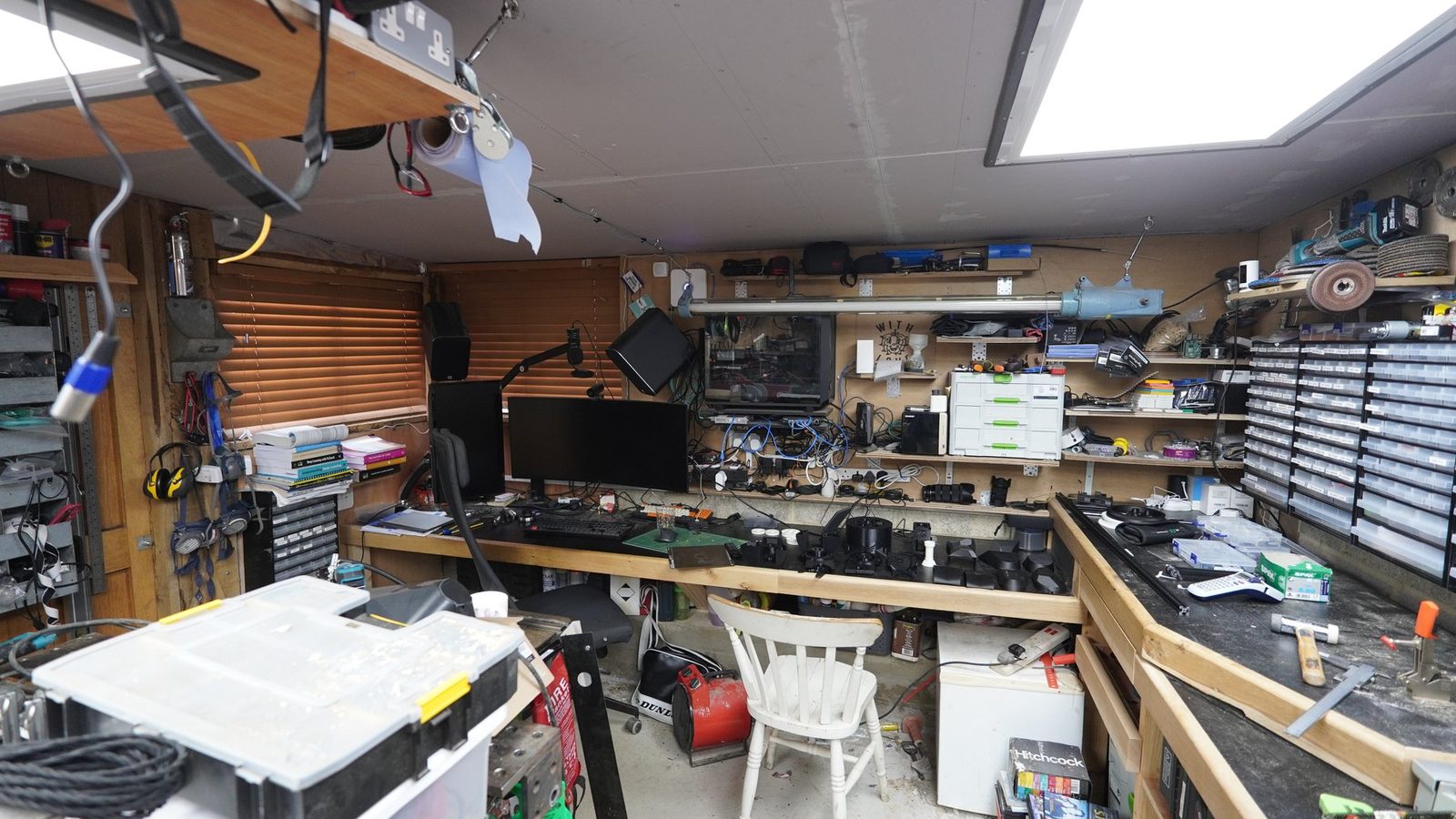 Workshop shelves and tools used for robot arm work.
