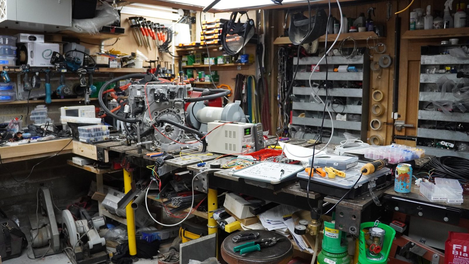 Workshop with robot arm project parts and tools.