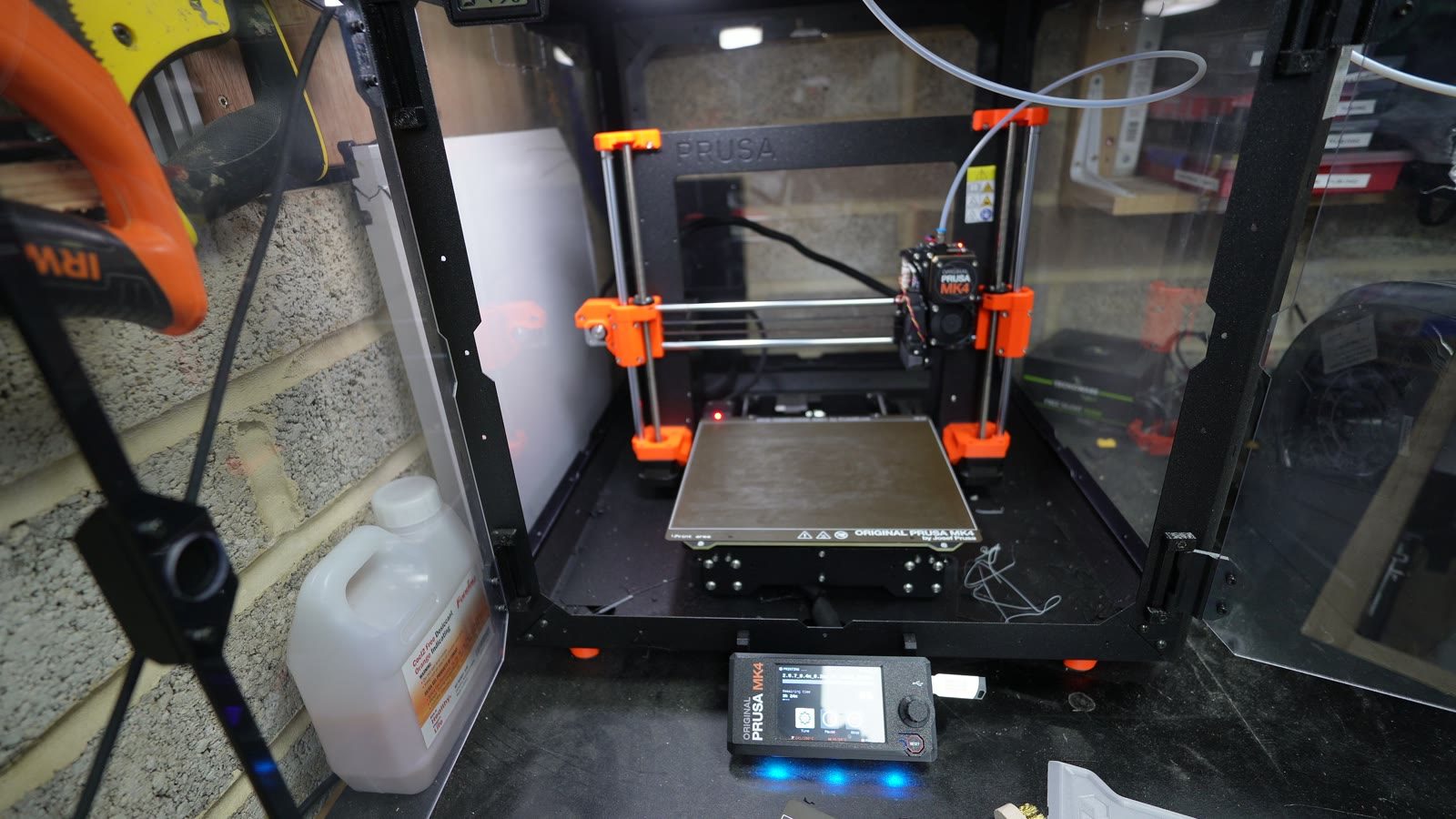 A 3D printer producing a robot arm component.