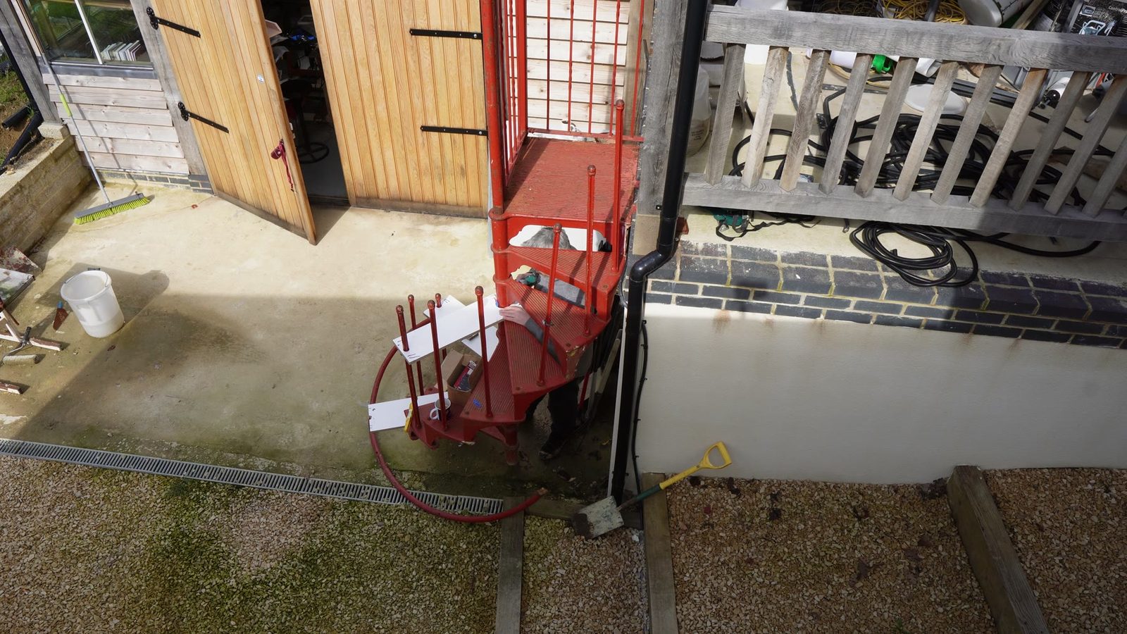 Overhead view of the red spiral staircase before finishing work.