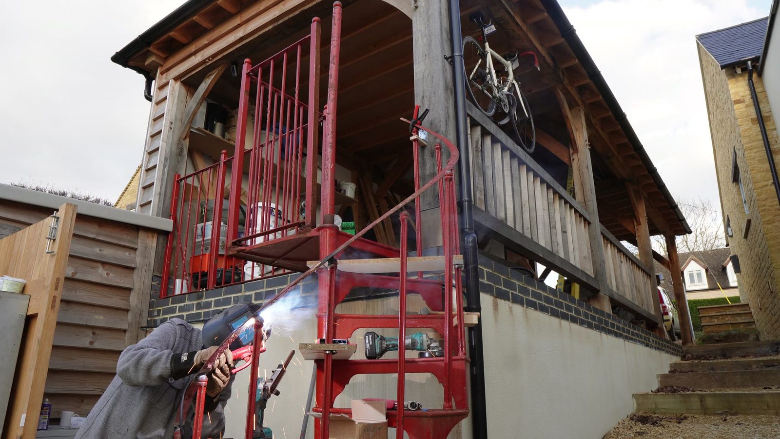 Preparing the spiral staircase handrail during fabrication.