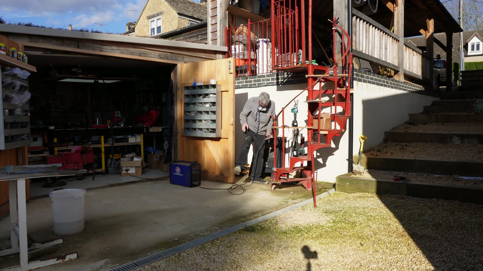 A wide view of the spiral stair work area, scaffold and workshop opening.
