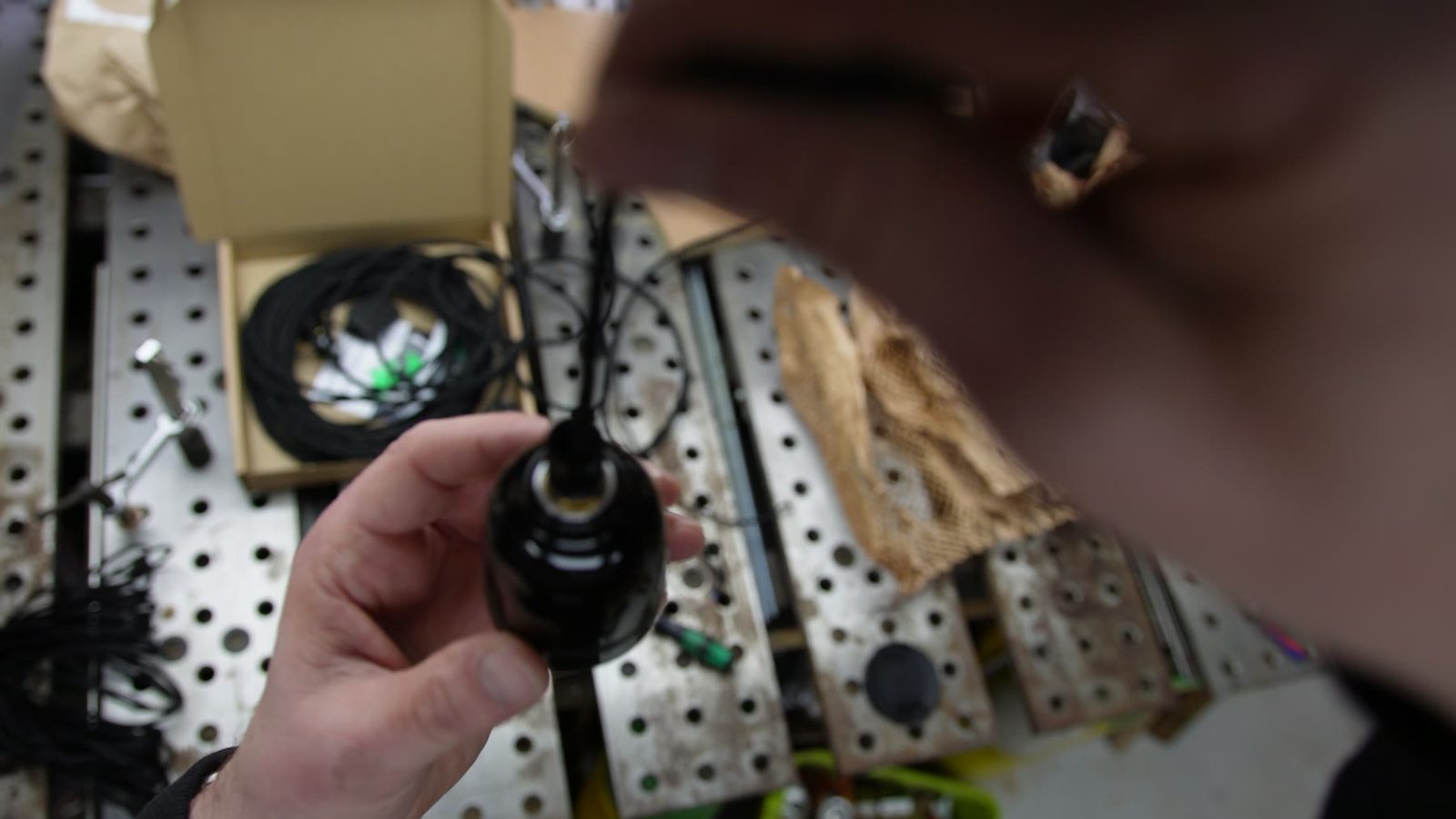 Close-up of a bulb holder and twisted cable during assembly.