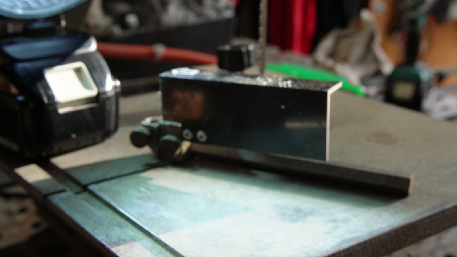 A small block being cut on a workshop saw for the vintage string lights.